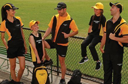 Junior sports team in matching branded training kit at a club ground